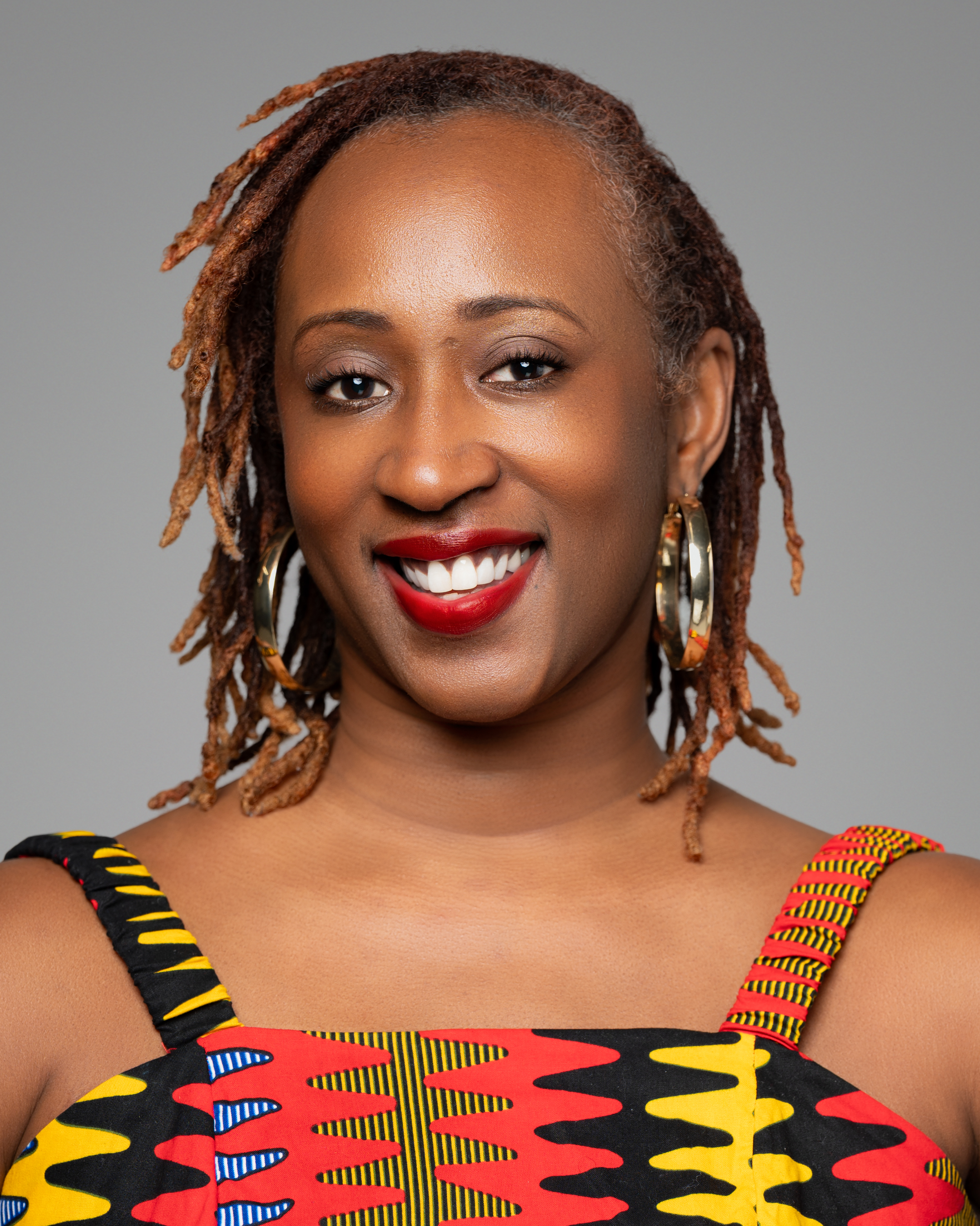 headshot of Tamara Irving, she is wearing an orange blaze and has a big smile